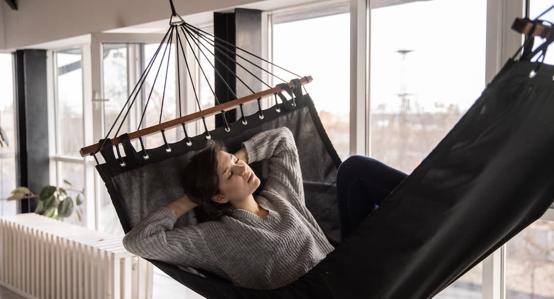 tired woman sleeping in cozy hammock in a flat